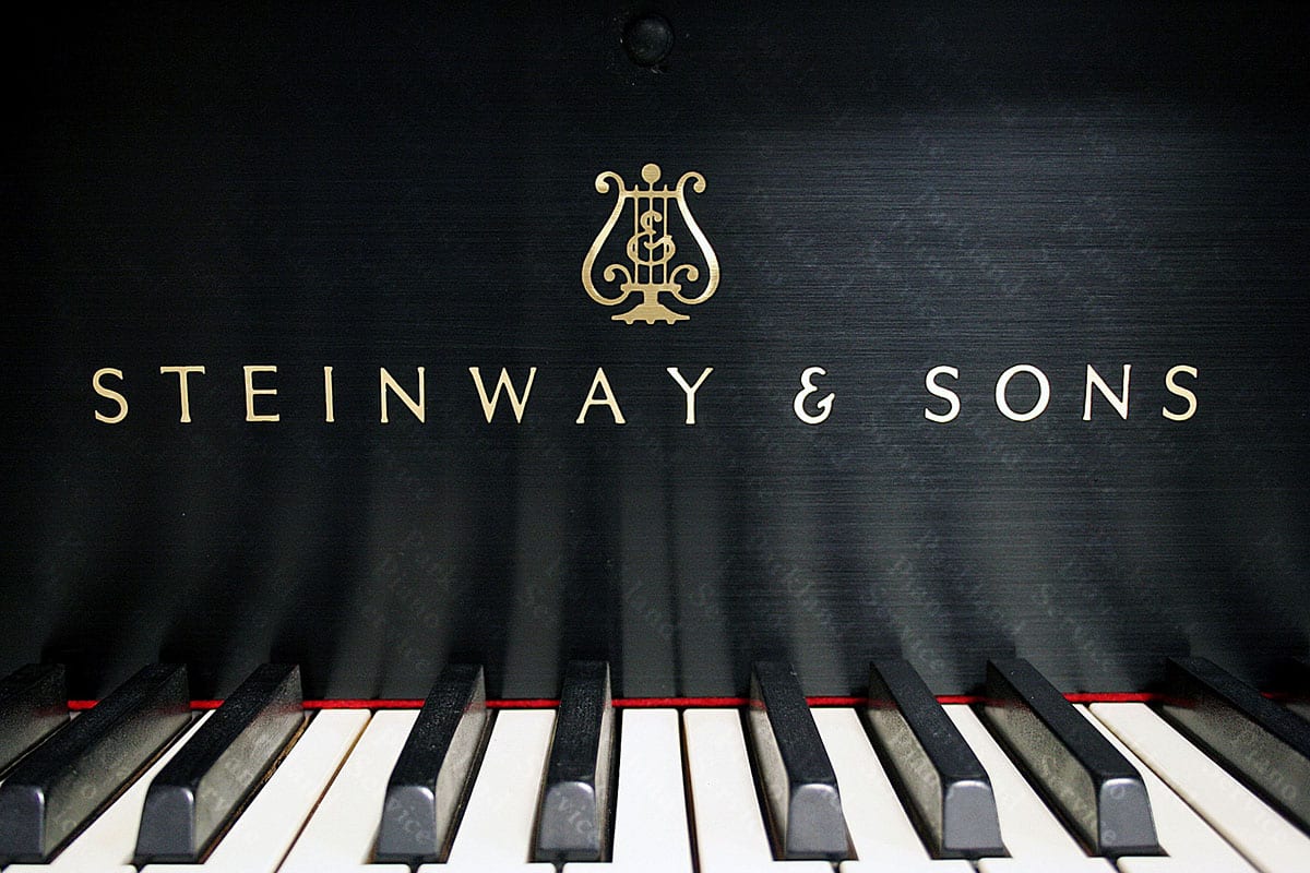 Rebuilt Steinway & Sons baby grand piano in brushed satin black with red felt and contemporary Steinway logo