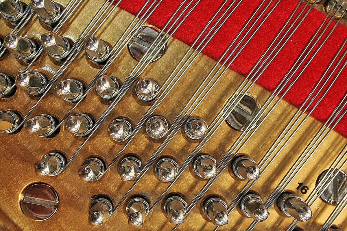 Newly installed replacement strings and felt on rebuilt Steinway grand piano